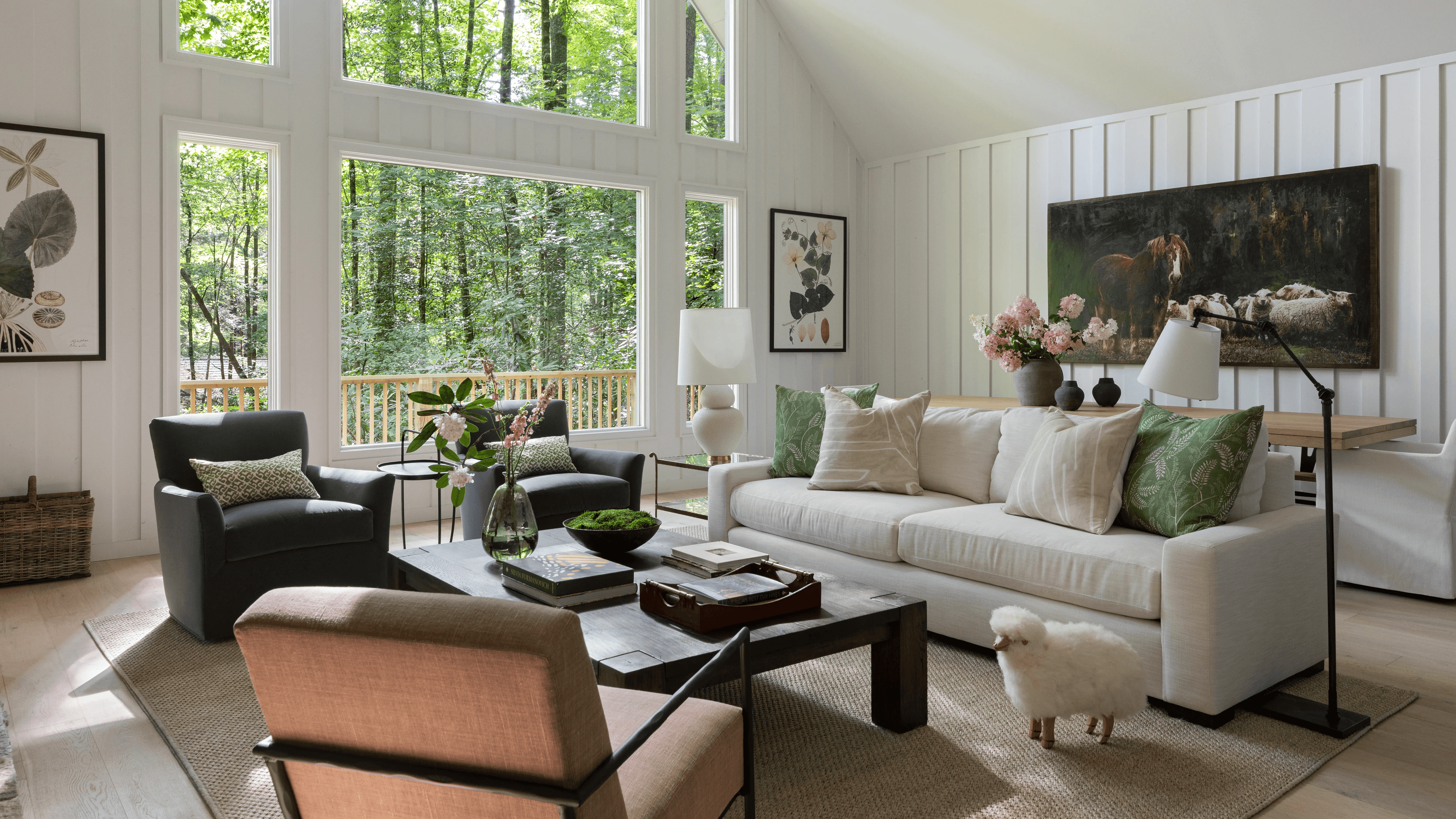A beautiful modern farmhouse living room featuring shiplap walls, neutral colors, natural wood beams, and vintage accents with a cozy seating area