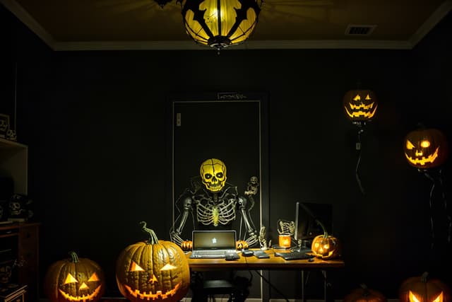 Haunted Halloween home office vignette with raven illustrations, carved pumpkins, smoky violet lighting, velvet textures, and an antique writing desk, photographed in hyper-realistic 8K cinematic lighting. Haunted Halloween home office vignette with raven illustrations, carved pumpkins, smoky violet lighting, velvet textures, and an antique writing desk, photographed in hyper-realistic 8K cinematic lighting.