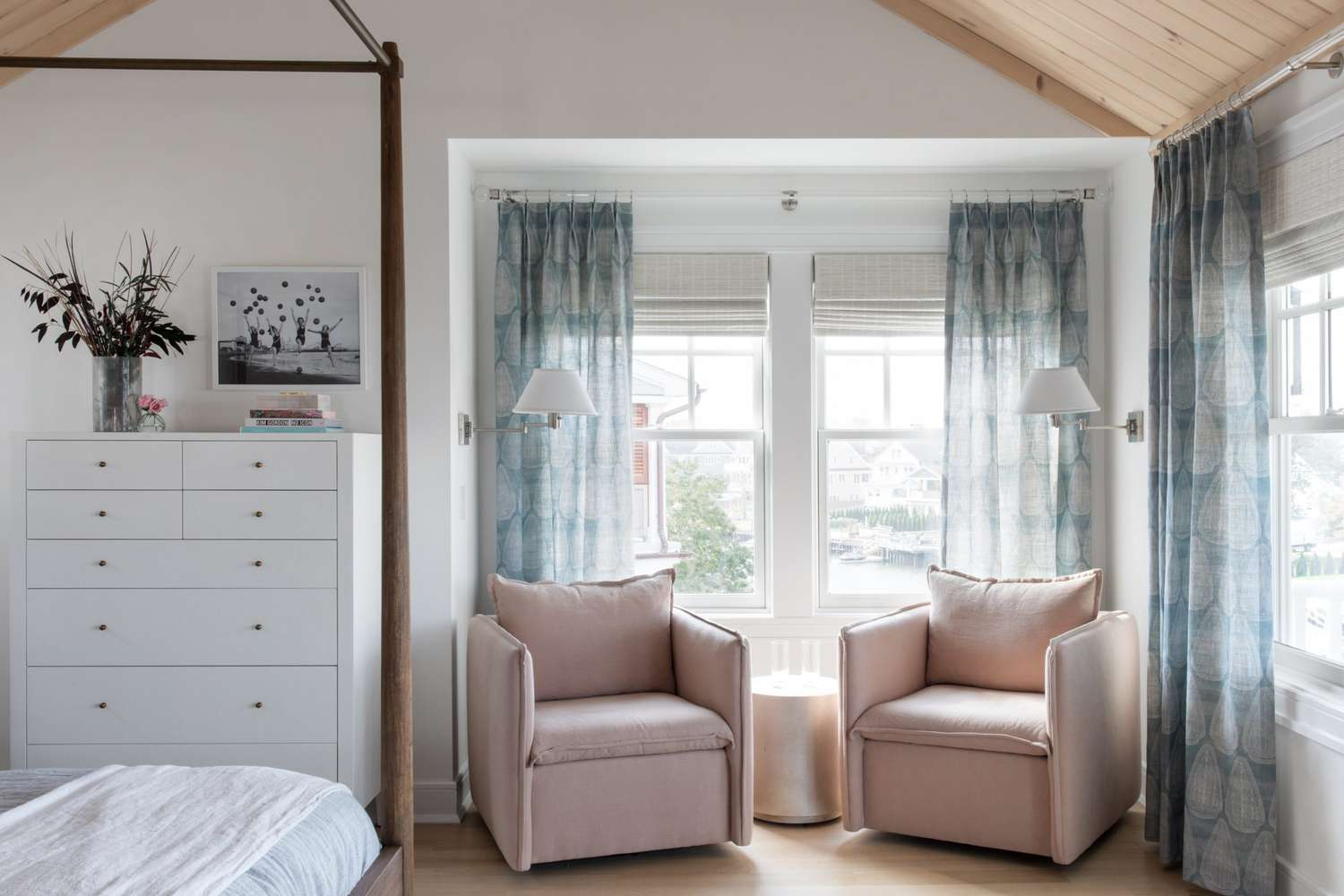 Window corner showing layered treatments with sheer white curtains and blackout panels, demonstrating how proper window dressing enhances bedroom tranquility