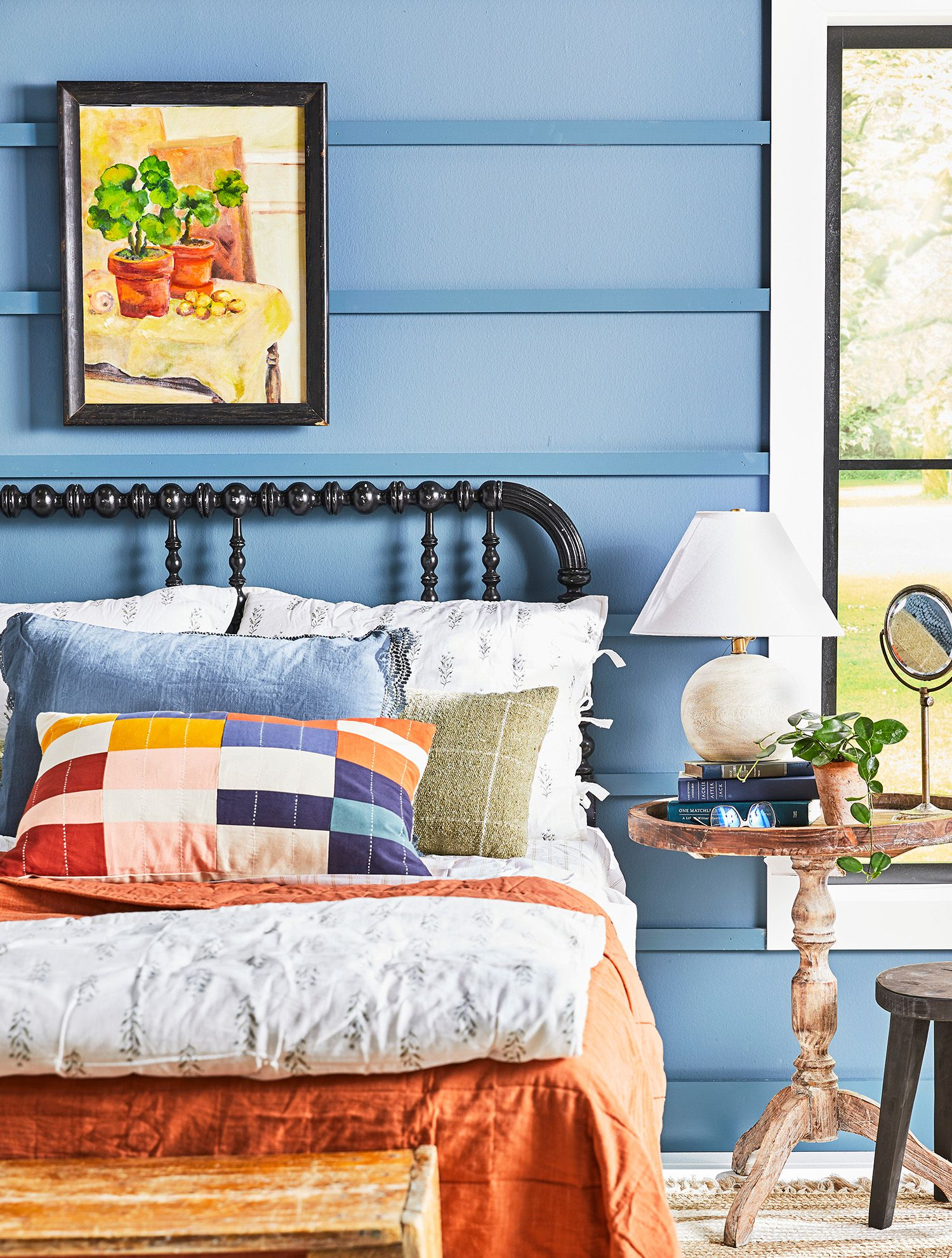 Bed styling showing an artful arrangement of throw pillows in various textures and neutral tones, demonstrating layering techniques for bedroom decor