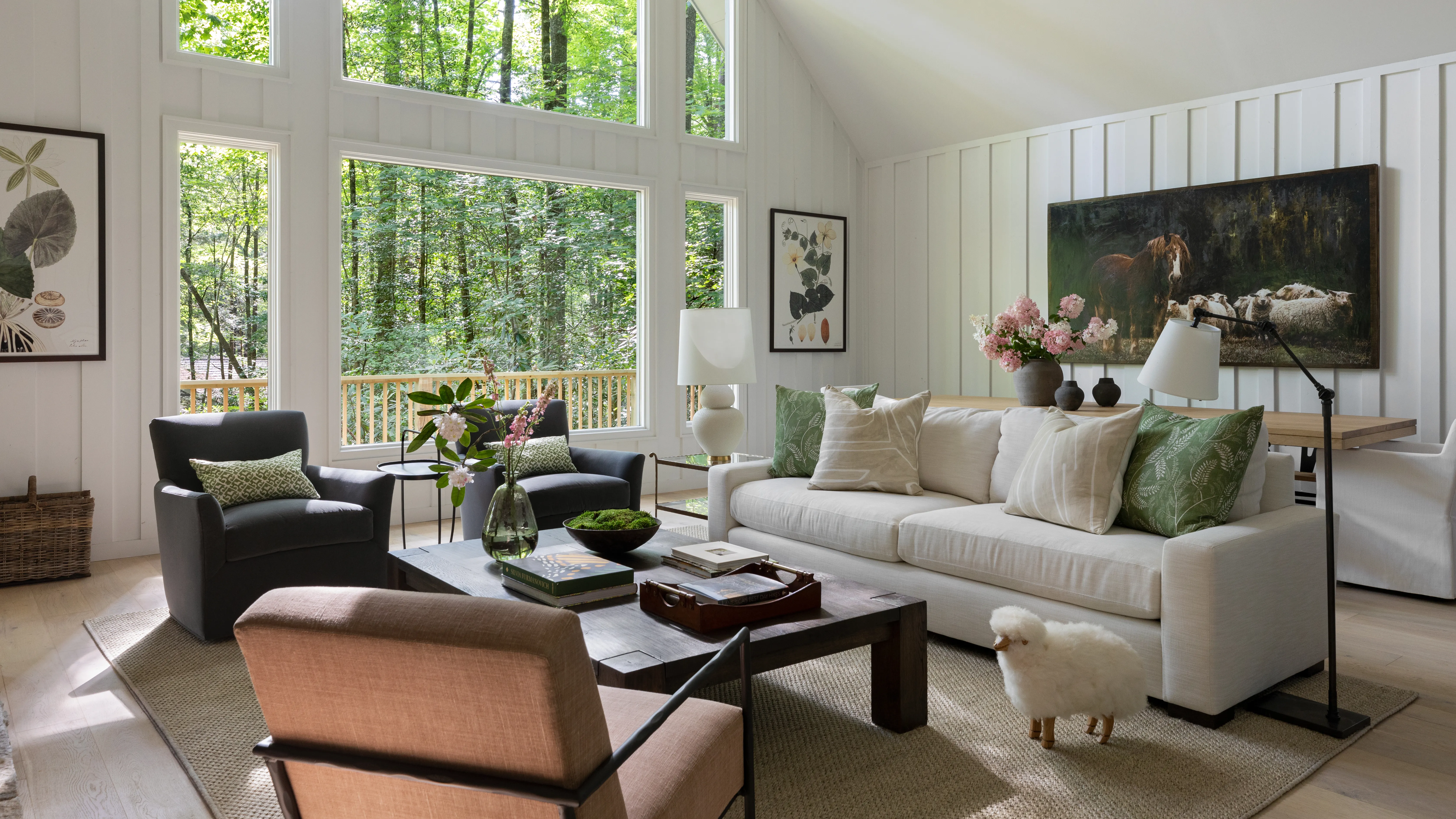 A beautiful modern farmhouse living room featuring shiplap walls, neutral colors, natural wood beams, and vintage accents with a cozy seating area