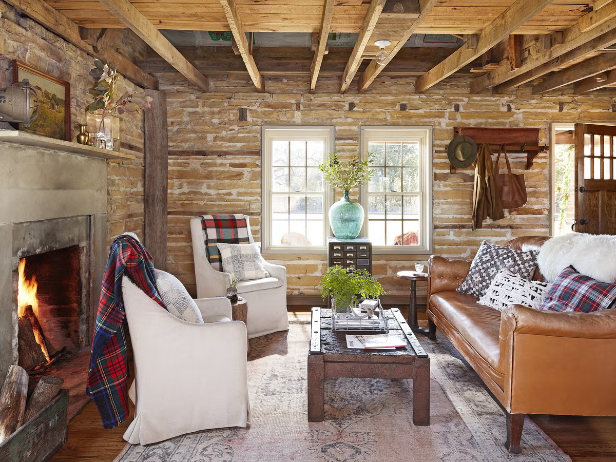 A cozy farmhouse living room with a large sectional, reclaimed wood coffee table, and shiplap accent wall